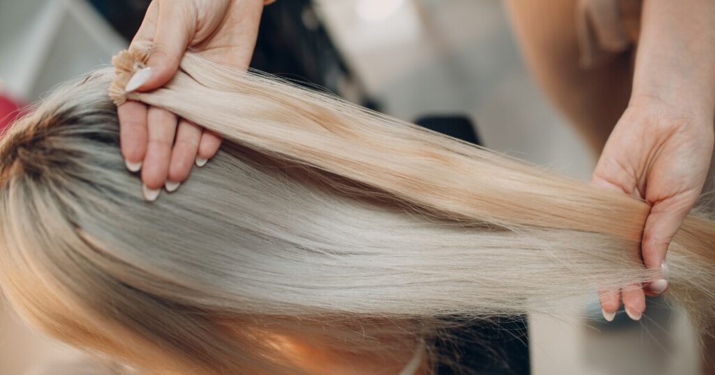 hair stylist matching weft extensions to blonde hair