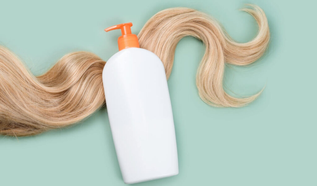 conditioner bottle with no logo sitting on blonde hair
