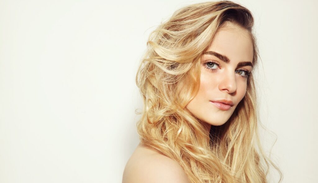 young woman with blonde hair baring her shoulder